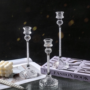 Three crystal glass candle holders with diamond filling and faceted base for home decor
