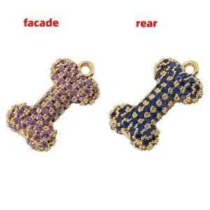 Bone-shaped heart pendant with purple and blue crystals in gold setting, front and rear view