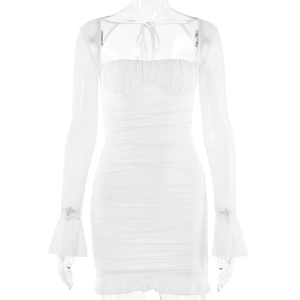 Detail of white off-shoulder mini dress featuring glitter mesh fabric and ruffled edges