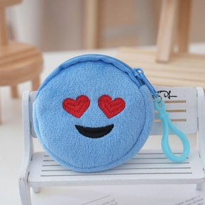 Detail of round blue plush coin purse with heart-eye emoji embroidery and clip