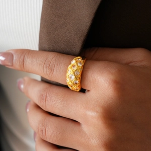 Detail of 24k gold plated geometric lattice ring with sparkling cubic zirconia inlay