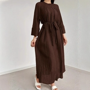 Detail of dark brown pleated midi dress with vertical texture and waist tie belt