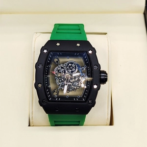 Detail shot of green rubber strap and hollow dial showing mechanical gear movement