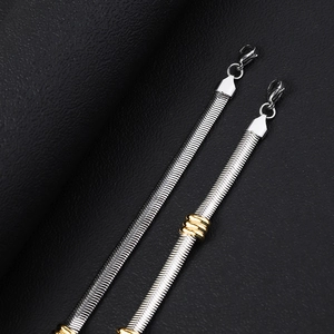 Detailed macro view of 6mm stainless steel snake chain with gold bead accents and lobster clasp