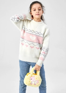 Toddler girl holding a yellow plush unicorn handbag with cute embroidered details