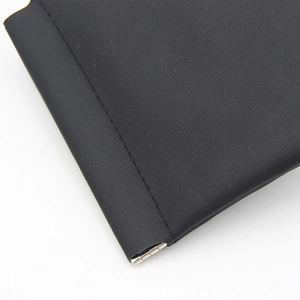 Close-up of black leather glasses case showing fine texture and neat stitching details