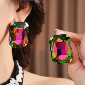 Close-up of vintage large rectangular rhinestone earrings with colorful faceted stones