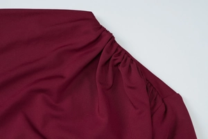 Detailed macro view of the ruched wine red fabric texture and quality stitching