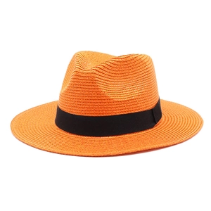 Detailed texture of bright orange straw fedora hat with a black decorative ribbon band