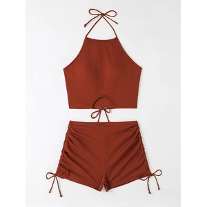 Detail of brick red ribbed bikini set with halter neck top and drawstring side shorts