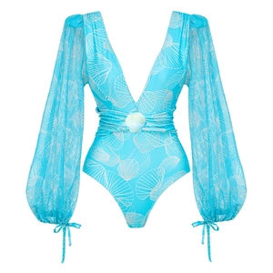 Detail of blue V-neck swimsuit featuring mesh puff sleeves and shell waist ornament