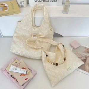 Detail of cream lace jacquard bags with vintage wooden beads strap and floral texture