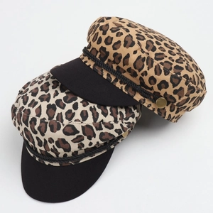 Detail of leopard print baker boy hats with black brim and gold button accents