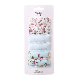 Detailed set of six floral and blue fabric hair clips displayed on a fashion card