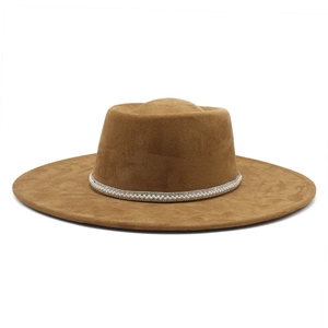 Close-up of brown suede wide brim hat featuring elegant pearl and rhinestone hatband