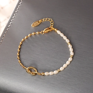 Close-up of knot pearl bracelet with gold metal chain and adjustable lobster clasp