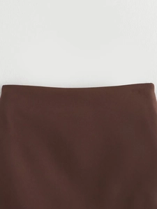 Detailed view of dark brown skirt waistline with smooth texture and clean finish