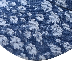 Detail of premium thick denim baseball cap with white floral embroidery and neat stitching