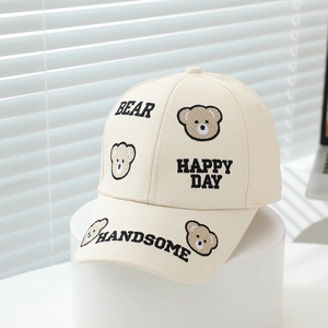 Detail of beige cotton baseball cap with cute bear embroidery and decorative text