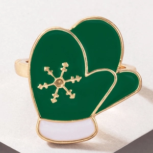 Close-up of a green enamel Christmas glove napkin ring with golden snowflake detail