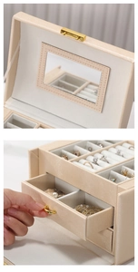 Detail view of large beige PU leather jewelry box with mirror and golden handles