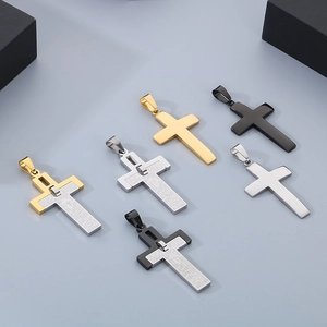 Detail of stainless steel cross pendants with engraved scripture in gold, silver and black