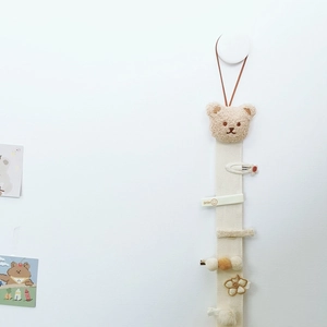 Close-up of plush bear wall-mounted organizer for kids' hair clips and accessories