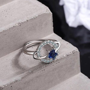 Silver adjustable star ring with blue cubic zirconia and polished metal finish