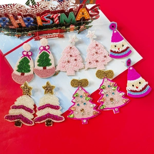 Handmade beaded Christmas earrings featuring festive trees and Santa hat motifs