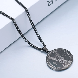 Macro shot of black stainless steel round pendant featuring Archangel Michael engraving