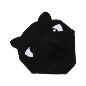 Close-up of cat-ear knit hat featuring bold black and white eye patterns and ribbed edges