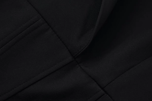 Primer plano de la textura de tela negra con costuras detalladas y tejido de calidad