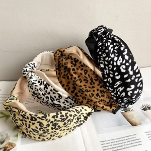 Detail of wide knotted headbands featuring leopard prints and wave patterns in various colors
