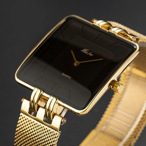 Close-up of a classic square gold mesh strap quartz watch with a sleek black dial