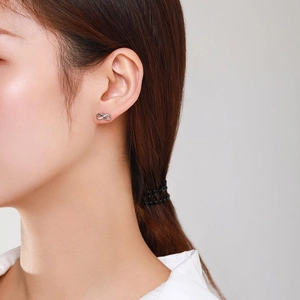S925 sterling silver infinity earrings with cubic zirconia worn by a female model