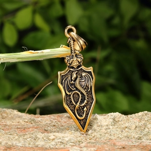 Golden dragon shield pendant with embossed dragon wing design in vintage metal finish