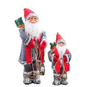 Set of two decorative Santa Claus figurines in grey robes with red accents on white background