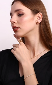 Detail of 18K gold plated bow earrings and ring set with sparkling pave diamonds