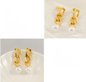 Detail of 18K gold-plated Cuban chain earrings with round white pearl drop on white silk