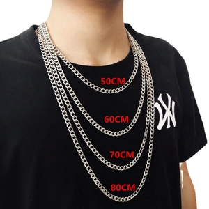 Silver stainless steel Cuban link chains shown in 50cm to 80cm lengths on a model