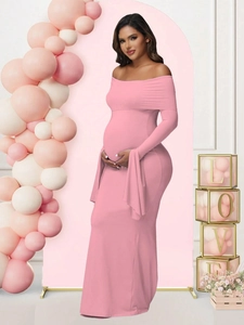 Close-up of pink off-shoulder maternity evening dress with elegant flared sleeves