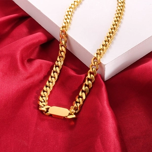 Polished gold Cuban link chain necklace for women on elegant red and white background