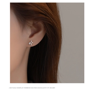 Detailed view of s925 silver star stud earring with a single sparkling zircon on ear