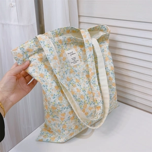 Floral canvas tote bag with yellow and green flower prints and sturdy dual handles