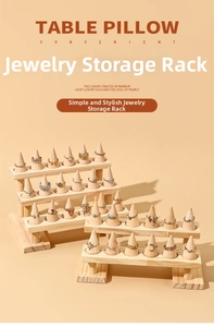 Close-up of tiered solid wood ring display stand with conical holders for jewelry