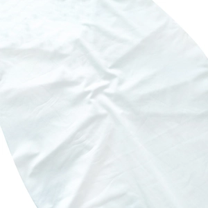 Close-up detail of white ruched fabric texture for summer bodycon dress with natural folds