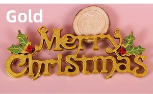 Detail of gold Merry Christmas sign with holly berries on pink background and wood block