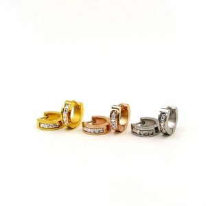 Close-up of titanium steel buckle earrings set with square zircons in gold, rose gold and silver