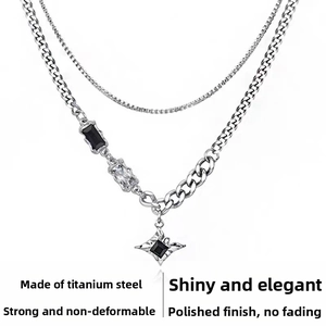 Detail of double-layer titanium steel star necklace with polished texture and zircon inlay