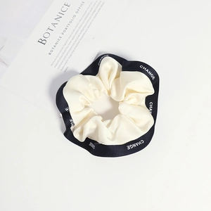 French style scrunchie with CHANGE lettering and contrast black and white silk texture